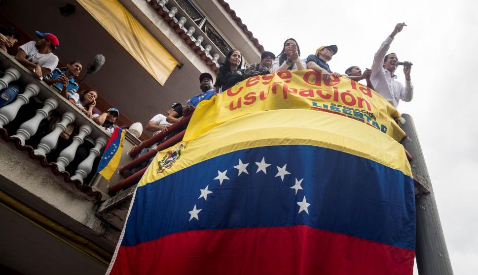 El jefe del Parlamento, Juan Guaidó (d-arriba), saluda a ciudadanos durante una visita este sábado, a la localidad de Charallave (Venezuela). /EFE