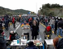 Varios manifestantes se avituallan durante el bloqueo de la autopista que enlaza España y Francia en el paso de La Jonquera. /EFE/Alejandro Garcia